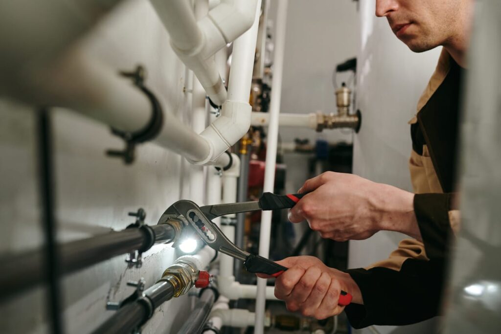 Plumbers maintaining commercial plumbing pipes in Atlanta