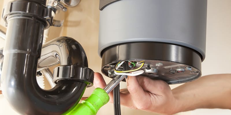 Technician repairing the heating element of a water heater in Atlanta